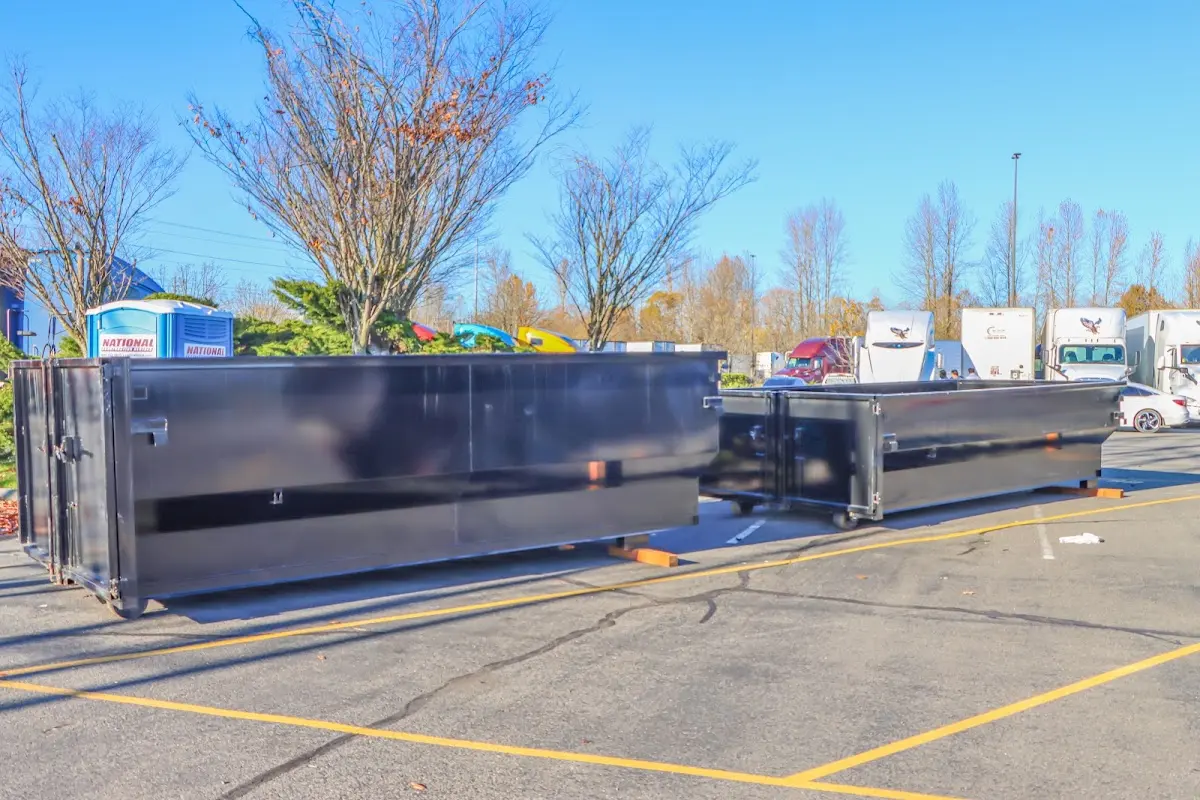 Professional dumpster rental service with roll-off container on residential driveway in Emeryville